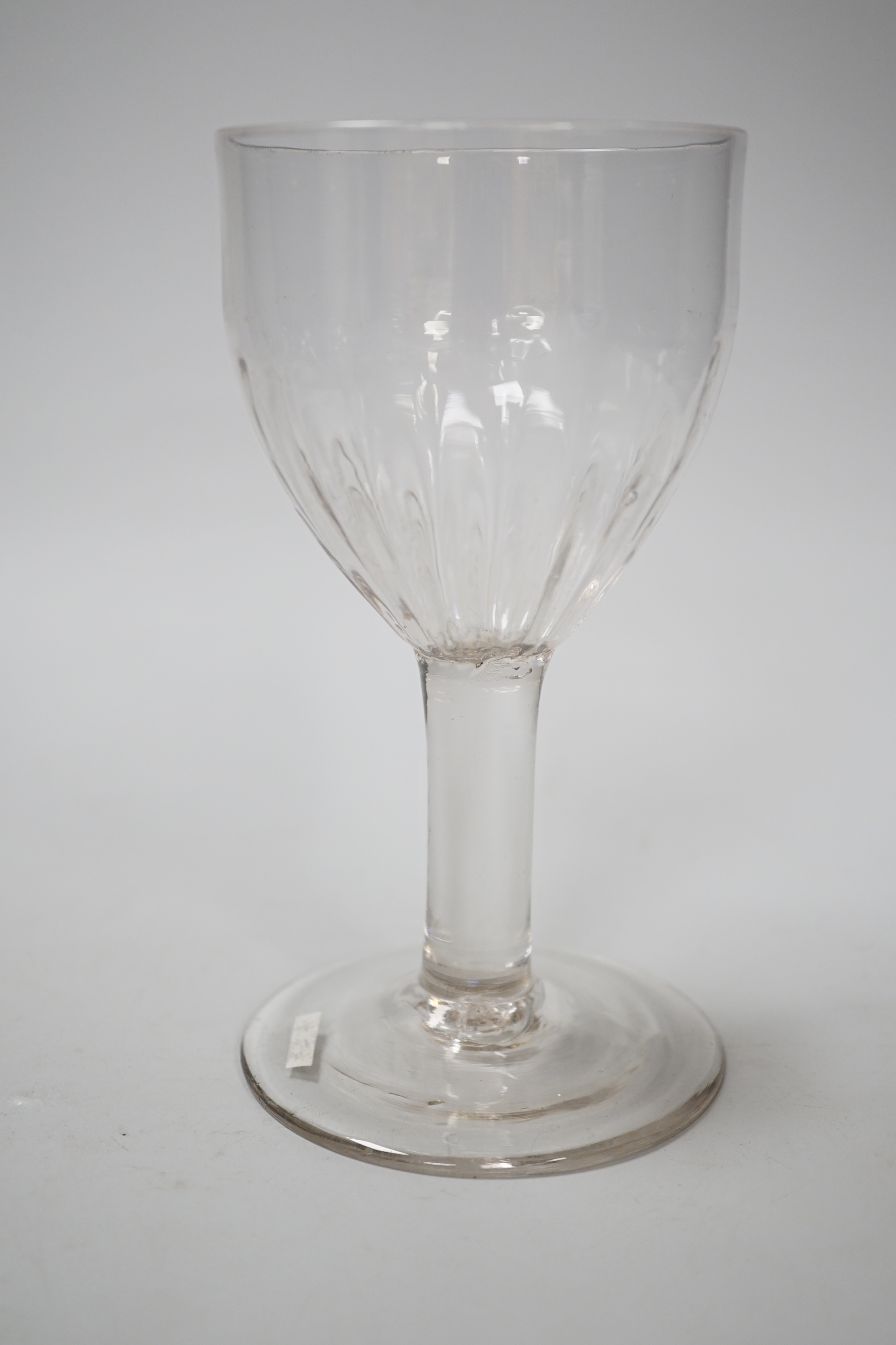 An English lead crystal flute moulded goblet, c,1740-50, a rare form with the lower half of the rounded ovoid bowl moulded with flutes on a plain stem and plain foot, 16.7cm high